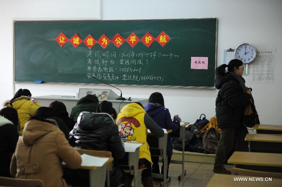 A faculty member leaves the examination room after distributing papers to examinees at Hangzhou Normal University in Hangzhou, east China's Zhejiang Province, Jan. 9, 2013. Practising for almost two years, examinations without invigilator have been conducted in many departments and schools of the university, involving some 80 courses, which aim at making examinees feel being trusted and encouraging them to maintain honest. (Xinhua/Ju Huanzong)  