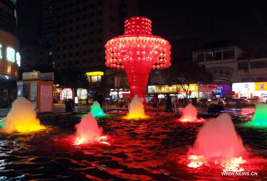 Photo taken on Jan. 9, 2013 shows a huge colored lantern and fountains at a square in Suzhou, east China's Jiangsu Province. Various colored lanterns were decorated in Suzhou to greet the upcoming Spring Festival, which falls on Feb. 10 this year. (Xinhua/Wang Jiankang)