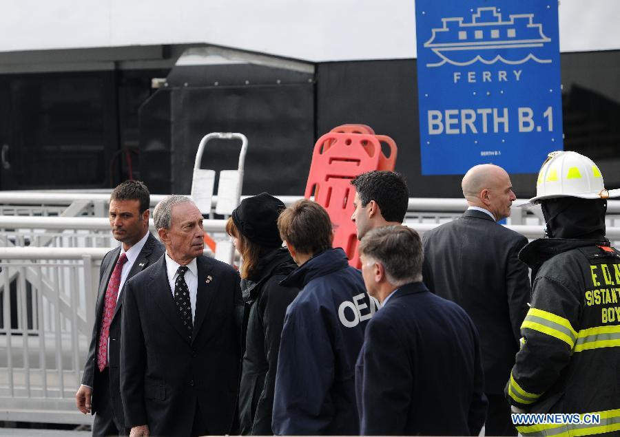 New York Mayor Bloomberg (2nd L) inspects the accident site where a ferry boat crashed into Pier 11 in lower Manhattan, New York, the United States, on Jan. 9, 2013. A high-speed ferry loaded with hundreds of commuters from New Jersey crashed into a dock near Wall Street on Wednesday during the morning rush hour, injuring 57 people. (Xinhua/Shen Hong)