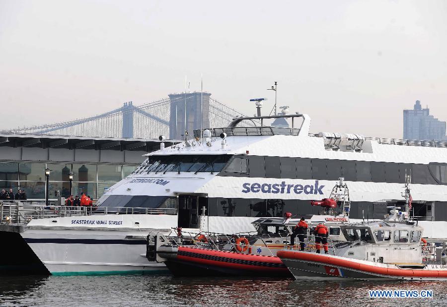 Rescue teams work at the accident site where a ferry boat crashed into Pier 11 in lower Manhattan, New York, the United States, on Jan. 9, 2013. A high-speed ferry loaded with hundreds of commuters from New Jersey crashed into a dock near Wall Street on Wednesday during the morning rush hour, injuring 57 people. (Xinhua/Shen Hong)