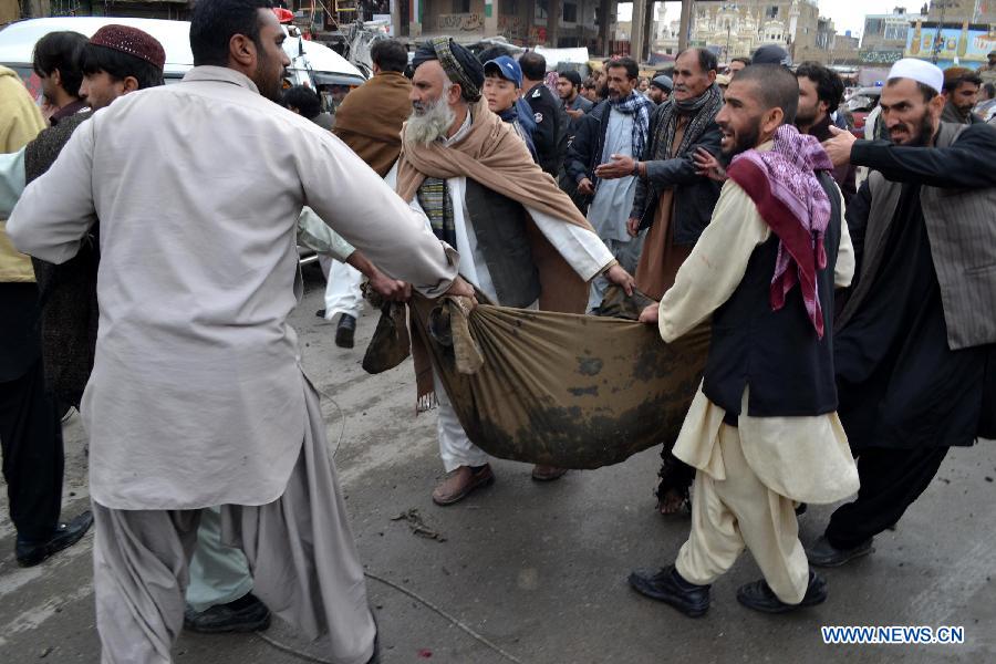 People move a body from the blast site in Quetta, southwest Pakistan, Jan. 10, 2013. (Xinhua/Mohammad) 