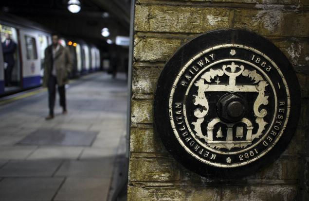 In the photo taken Tuesday, Jan. 8, 2013, people walk by Farringdon underground station, in London. The world's first subway system marked its 150th anniversary Wednesday, Jan. 9, 2013, with reports showing conditions way back when were much as they are today: Busy, congested and stressful for passengers. (People's Daily Online/AP)