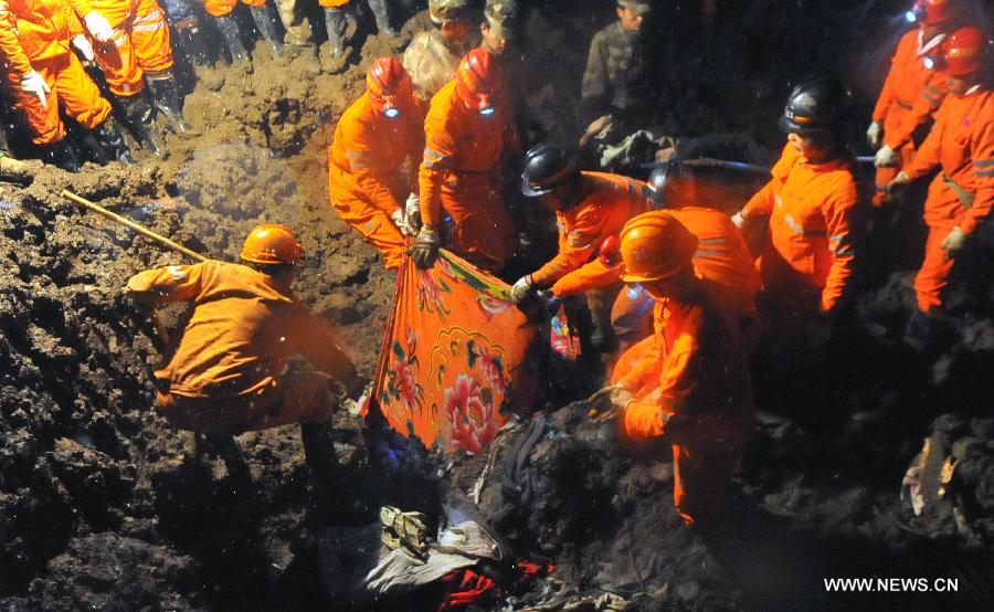 Rescuers find a victim's body at the mud-inundated debris after a landslide hit Gaopo Village in Zhenxiong County, southwest China's Yunnan Province, Jan. 11, 2013. (Xinhua/Chen Haining)