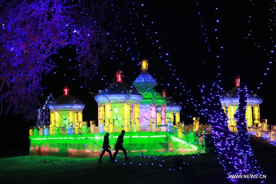 Visitors view the ice sculptures during the 16th Shenyang International Ice and Snow Festival in Shenyang, capital of northeast China's Liaoning Province, Jan. 10, 2013. The festival will last for three months. (Xinhua/Huang Jinkun)