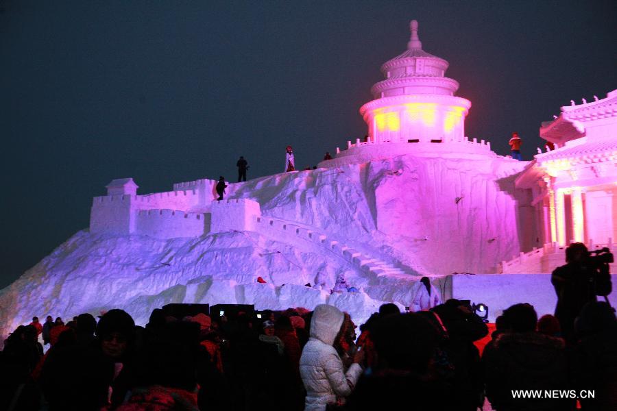 Visitors view the ice sculptures during the 16th Shenyang International Ice and Snow Festival in Shenyang, capital of northeast China's Liaoning Province, Jan. 10, 2013. The festival will last for three months. (Xinhua/Huang Jinkun)