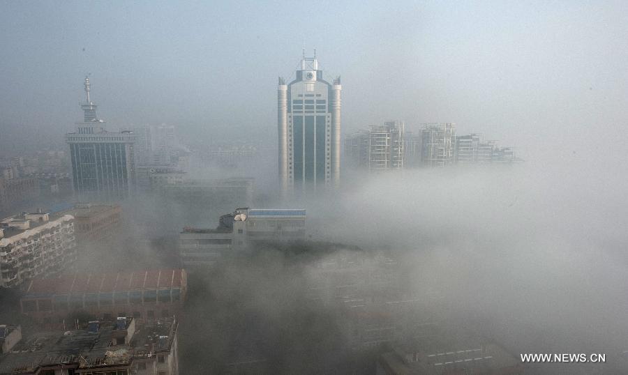 Buildings are seen amid dense fog in Wuhan City, capital of central China's Hubei Province, Jan. 12, 2013. (Xinhua/Cheng Min) 