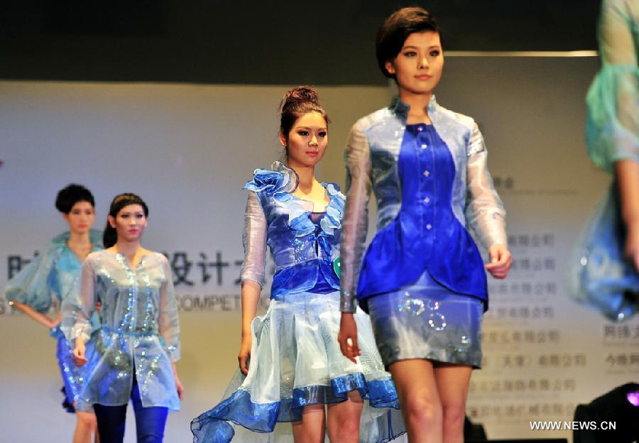 Models present outfits at a creative fashion design competition held at Tianjin Polytechnic University in north China's Tianjin, Jan. 11, 2013. The competition held its final here Friday. (Xinhua/Zuo Shan)