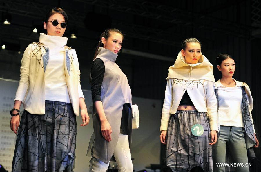 Models present outfits at a creative fashion design competition held at Tianjin Polytechnic University in north China's Tianjin, Jan. 11, 2013. The competition held its final here Friday. (Xinhua/Zuo Shan)