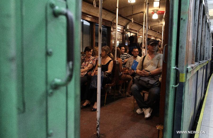 Passengers ride on a wagon of the A line subway in Buenos Aires, Argentina, on Jan. 11, 2013. The A line subway service would be closed since Jan. 12 and the Belgian original historic wooden cars, which have been in service for almost 100 years, would be repalced by upgraded Chinese-made wagons. (Xinhua/Alberto Raggio)