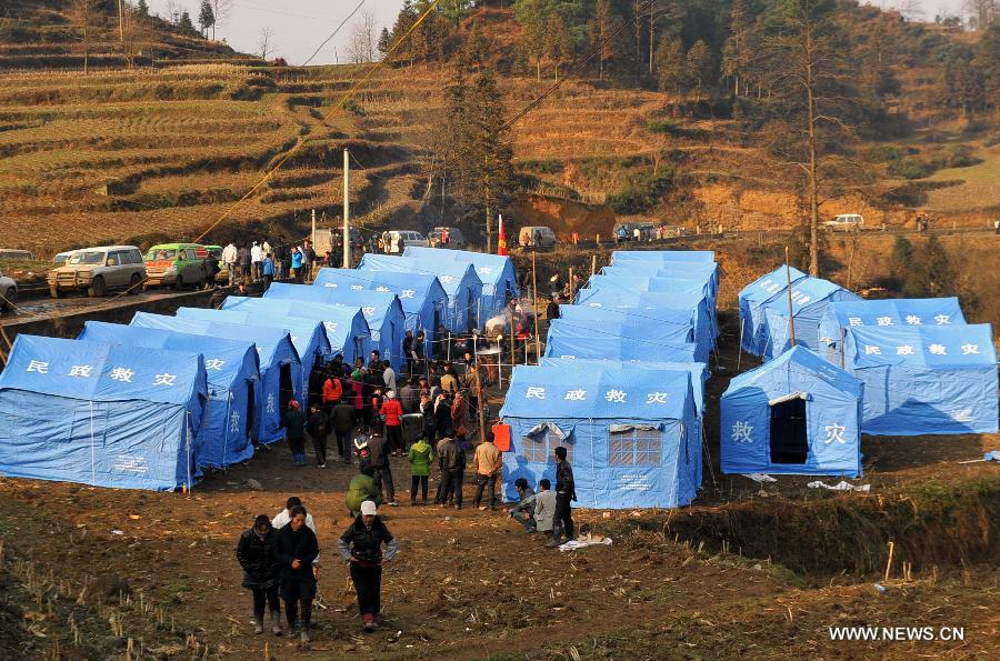 Photo taken on Jan. 12, 2013 shows tents installed for landslide-affected villagers at Gaopo Village in Zhenxiong County, southwest China's Yunnan Province. Landslide-affected villagers in Gaopo Village have been temporarily settled in tents and got life necessities. Forty-six people were killed in the Friday landslide. Another two people were injured. (Xinhua/Chen Haining) 