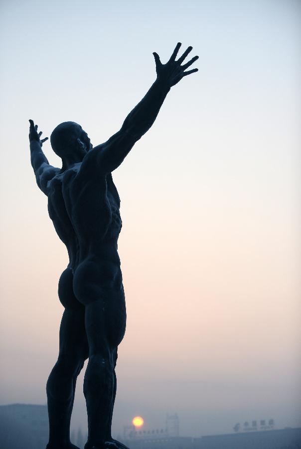 Photo taken on Jan. 13, 2013 shows a sculpture in the fog in Changchun, capital of northeast China's Jilin Province. Heavy fog hit Changchun on Sunday. (Xinhua/Lin Hong) 