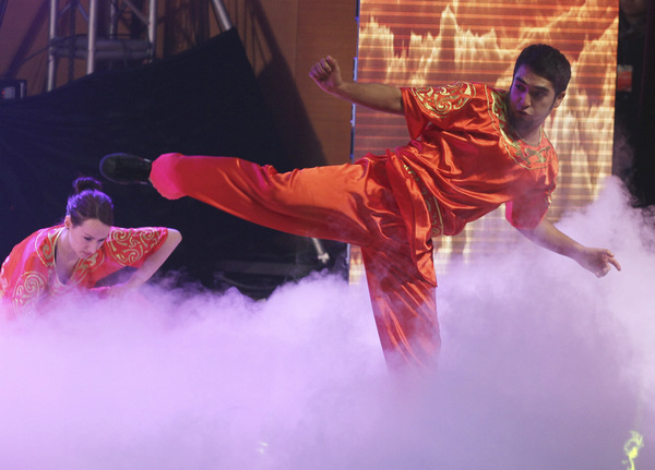 International students from the Capital University of Physical Education and Sports perform kung fu during the Ministry of Education's 2013 New Year reception for international graduates, held at the University of International Business and Economics in Beijing. (Photo by Zhu Xingxin / China Daily)