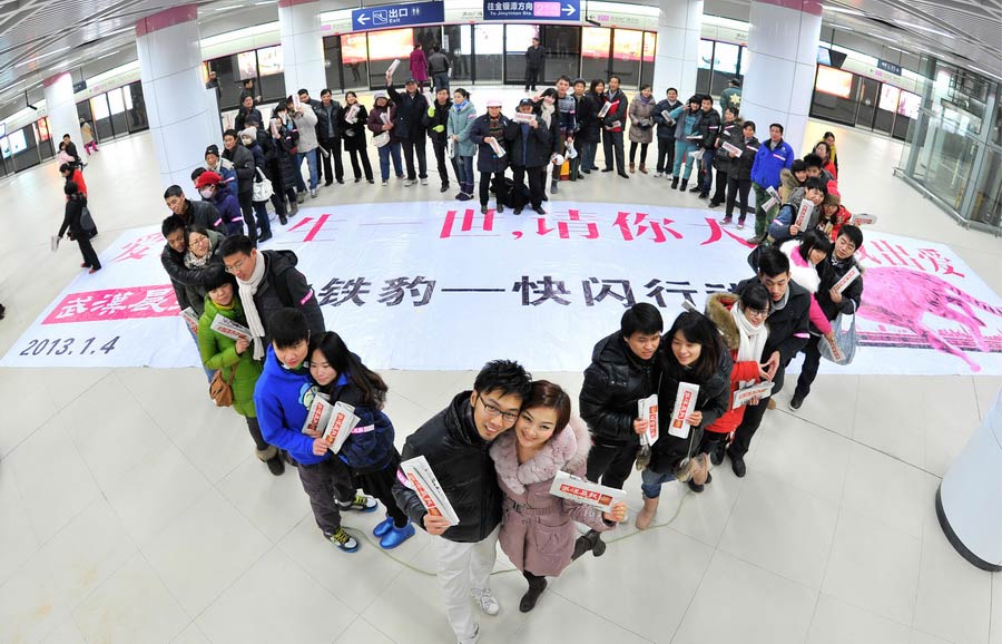 Young lovers form the shape of a heart for photo shooting and yell out “love you forever” in the subway of Wuhan at 13:14 p.m. on Jan. 4, 2013. “1314” sounds like"forever" in mandarin. (Xinhua/Chen Min)