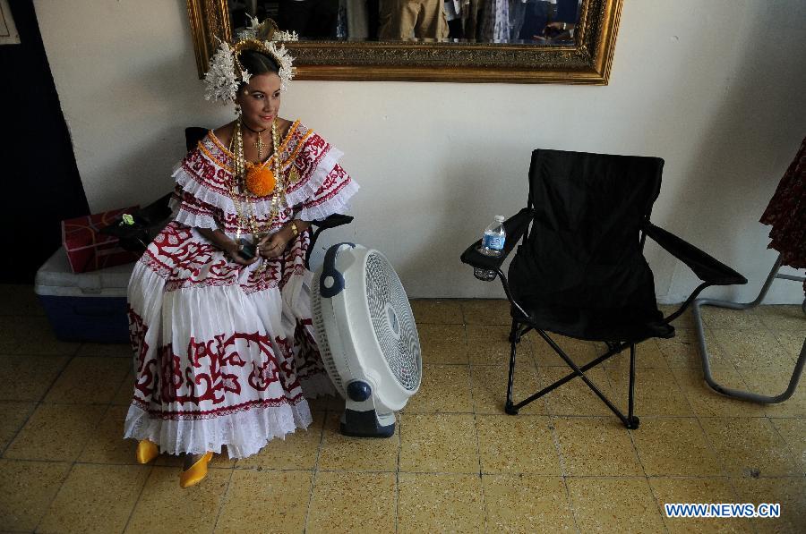 A woman wearing the traditional dress of Pollera waits to participate in the Parade of 1,000 Polleras in Las Tablas, Panama, on Jan. 12, 2013. Polleras are traditional handmade costumes worn by Panamanian women mostly in folklore festivities. According to parade organizers, almost every part of the costume is made by hand and the assortment of head, neck and chest jewelry worn with a pollera can cost as much as 20,000 U.S. dollars. (Xinhua/Mauricio Valenzuela)