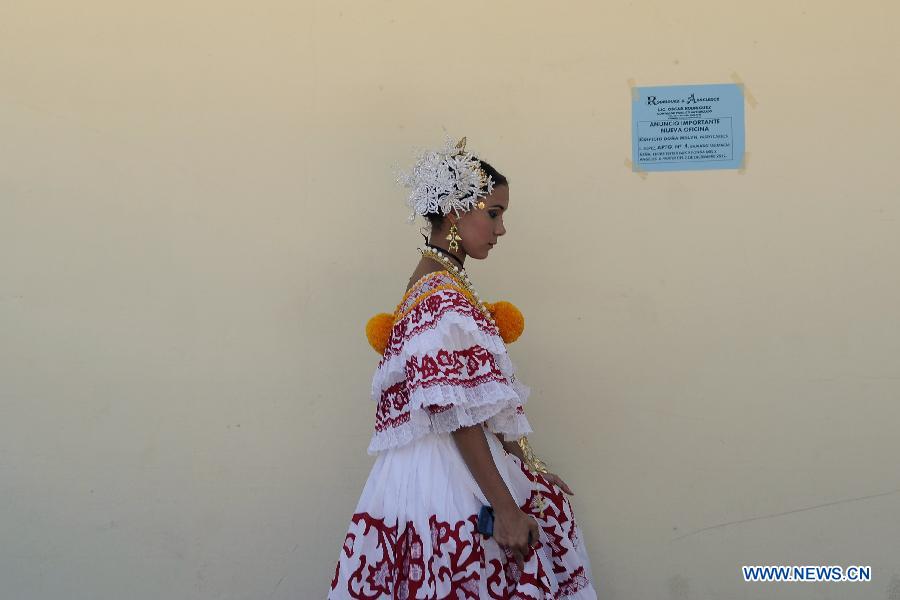 A woman wearing the traditional dress of Pollera walks to participate in the Parade of 1,000 Polleras in Las Tablas, Panama, on Jan. 12, 2013. Polleras are traditional handmade costumes worn by Panamanian women mostly in folklore festivities. According to parade organizers, almost every part of the costume is made by hand and the assortment of head, neck and chest jewelry worn with a pollera can cost as much as 20,000 U.S. dollars. (Xinhua/Mauricio Valenzuela) 