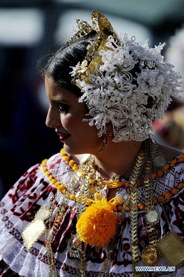 A woman wearing the traditional dress of Pollera participates in the Parade of 1,000 Polleras in Las Tablas, Panama, on Jan. 12, 2013. Polleras are traditional handmade costumes worn by Panamanian women mostly in folklore festivities. According to parade organizers, almost every part of the costume is made by hand and the assortment of head, neck and chest jewelry worn with a pollera can cost as much as 20,000 U.S. dollars. (Xinhua/Mauricio Valenzuela) 