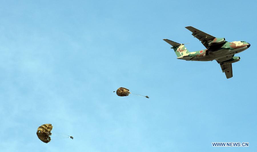 Members of Japan's Ground Self Defense Force 1st Airborne Brigade parachute into the air from a military transport aircraft during an exercise in Narashino, suburban Tokyo, Japan, Jan. 13, 2013. A total of 300 personnel, 20 aircraft and 33 vehicles took part in the open exercise at the defense force's Narashino training ground. (Xinhua/Ma Ping)