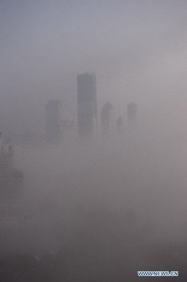 Heavy fog envelops Nanchang, capital of east China's Jiangxi Province, Jan. 14, 2013. Nanchang's air has been heavily polluted for five days in a row, according to local meteorological authorities. (Xinhua/Zhou Mi) 