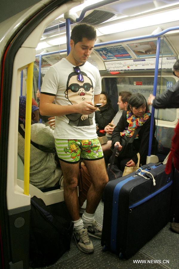 A man without pants takes part in the worldwide "No Pants Subway Ride" on a subway train in London, Britain, on Jan. 13, 2013. (Xinhua/Bimal Gautam) 