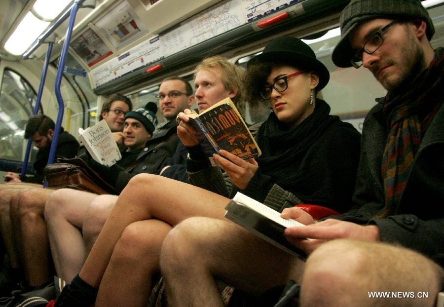 People without their pants take part in the worldwide "No Pants Subway Ride" on a subway train in London, Britain, on Jan. 13, 2013. (Xinhua/Bimal Gautam) 
