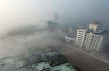 Buildings are seen amid dense fog in Wuhan City