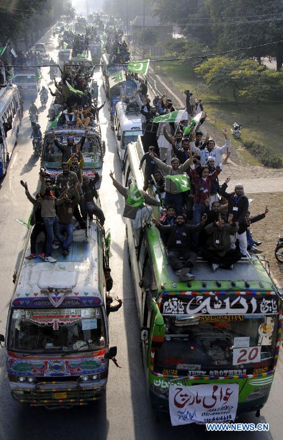 Supporters of Dr Tahir-ul-Qadri ride on vehicles during a long-march in eastern Pakistan's Lahore, Jan. 13, 2013. A Pakistani religious leader, Dr Tahir-ul-Qadri, started a long-march from Lahore to Islamabad to call for electoral reforms Sunday, local media reported. (Xinhua/Sajjad)