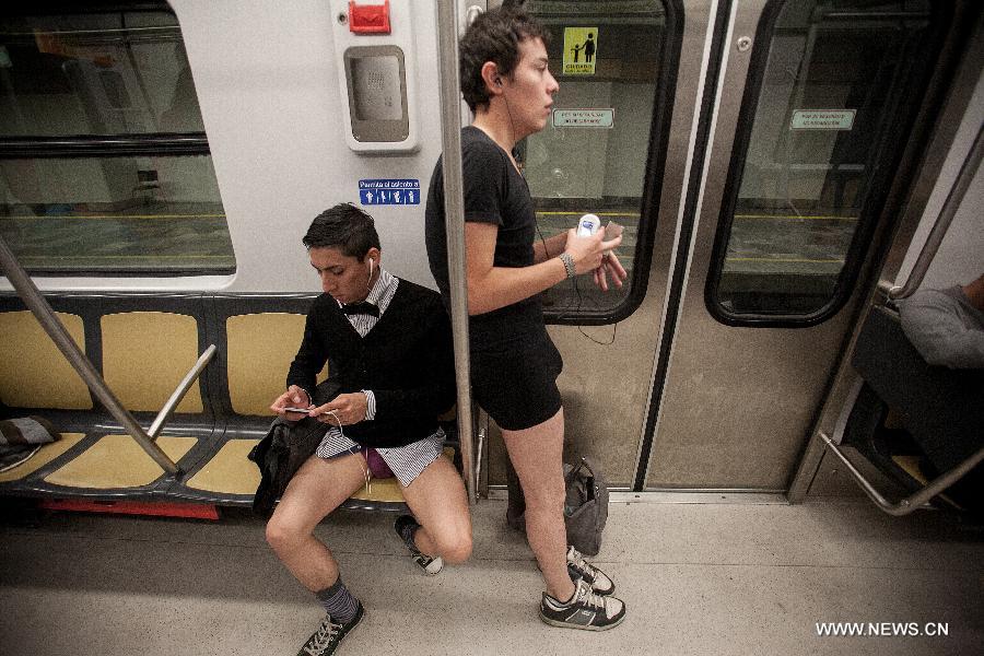 People without their pants take part in the worldwide "No Pants Subway Ride" event in a subway train in Mexico City, capital of Mexico, on Jan. 13, 2013. (Xinhua/Pedro Mera) 