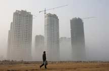 A man walks on a fog-shrouded road in Lianyungang City