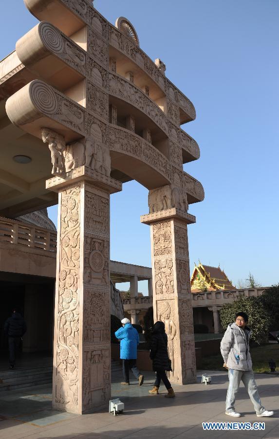 Photo taken on Dec. 31, 2012 shows tourists visiting the Indian-style Buddha hall of the Baima Temple, or the White Horse Temple, in Luoyang City, Central China's Henan Province. Visitors can see Buddha halls with different styles of foreign countries at the Baima Temple, the oldest Buddhist temple in China.(Xinhua/Li Bo) 