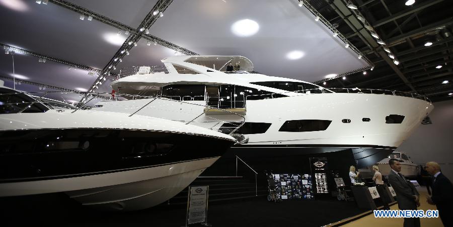 Visitors chat with exhibitors at the 58th London Boat Show, held at the ExCeL Exhibition and Convention Centre in London, Jan. 14, 2013. The 58th London Boat Show showcases, demonstrates and sells maritime equipments including luxury yachts, dinghies, boating equipment and clothing with interactive sections and features attractions devoted to boating until Jan. 20, 2013. (Xinhua/Wang Lili) 