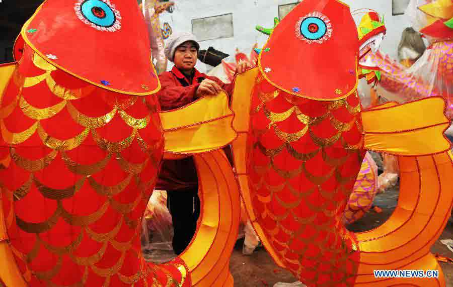 A worker decorates a lantern in a lantern factory in Zhoucun District of Zibo, east China's Shandong Province, Jan. 14, 2013. As traditional Chinese Spring Festival is coming, lantern factories here have come to a busy production season. (Xinhua/Dong Naide)