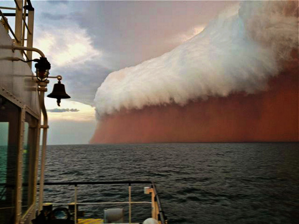 An intense dust storm creates the spectacular scene of rare "red wave" off the coast of Onslow in Western Australia. (Xinhua/AFP)