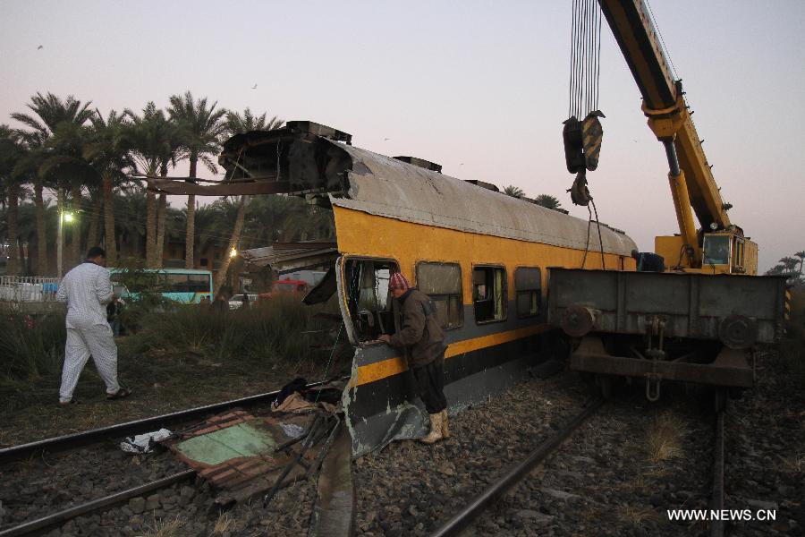Photo taken on Jan. 15, 2013 shows the train derail accident site at the Giza neighborhoods of Badrashin, Egypt. A military train derailed in Egypt early Tuesday, killing at least 19 conscripts and injuring 107 others, a spokesman from the Health Ministry said in a statement to official MENA news agency. (Xinhua)