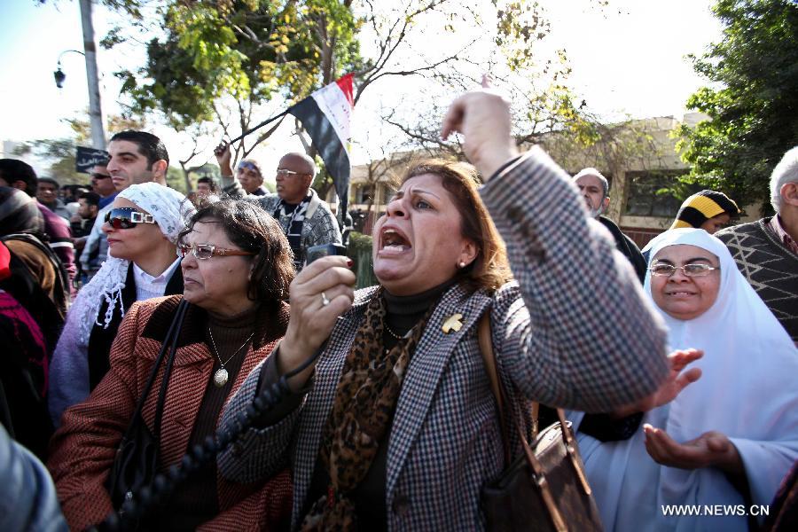 Anti-Morsi protesters shout slogans against the constitution in front of the Supreme Constitutional Court (SCC) in Cairo, Egypt, Jan. 15, 2013. Egyptian Supreme Constitutional Court is set to review Tuesday lawsuits against the Shura Council (upper house of the parliament) which currently assumes legislative power, as well as the dissolved Constituent Assembly which wrote the recently approved constitution. (Xinhua/Amru Salahuddien)