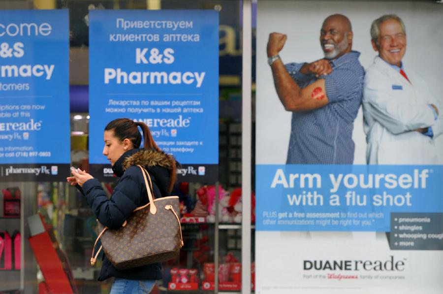 A woman walks past a CVS pharmacy store in New York, the United States, Jan. 15, 2013. As of Sunday, more than 20,000 cases of influenza have been reported in New York State for this season, far more than the 4, 404 cases that were reported in the last season. (Xinhua/Wang Lei) 
