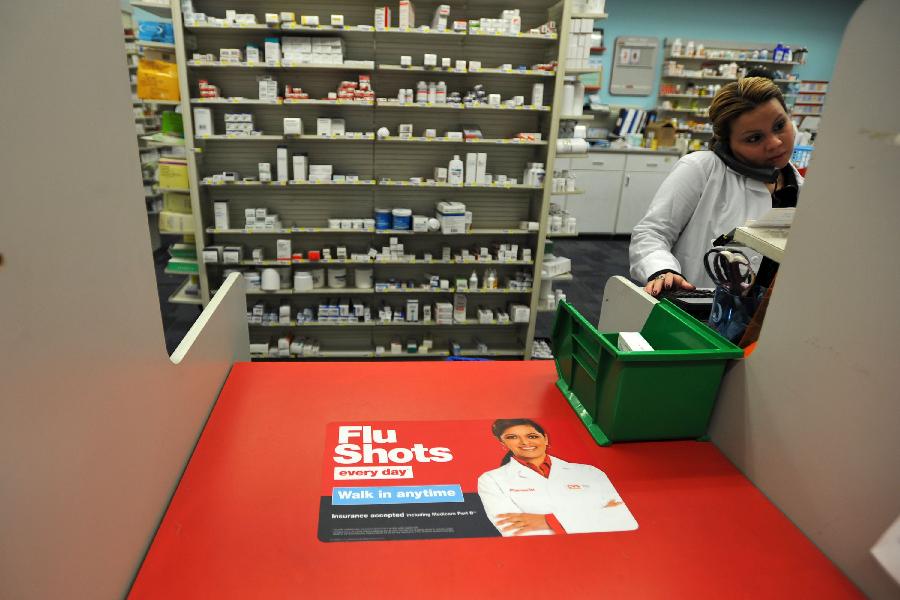 A staff member works at a CVS pharmacy store in New York, the United States, Jan. 15, 2013. As of Sunday, more than 20,000 cases of influenza have been reported in New York State for this season, far more than the 4, 404 cases that were reported in the last season. (Xinhua/Wang Lei) 
