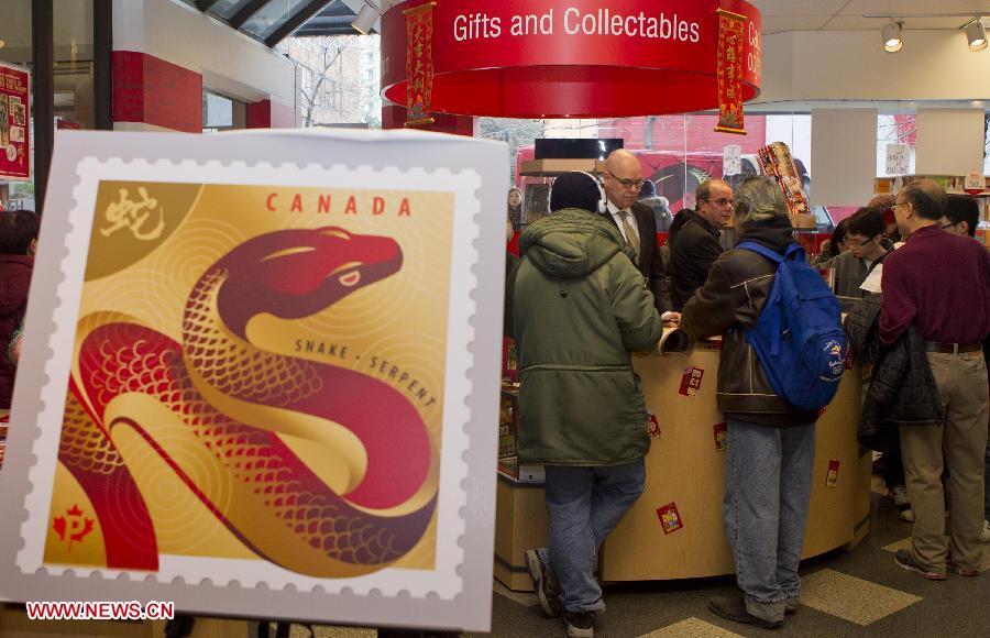 Collectors wait to buy the Year of the Snake stamps at a post office in Toronto, Canada, Jan. 8, 2013. Canada Post issued the Year of the Snake domestic and international rate stamps and collectibles on Tuesday in celebration of the Chinese Lunar Year of the Snake starting from Feb. 10. The stamps were designed by Joseph Gault and Avi Dunkelman. (Xinhua/Zou Zheng)