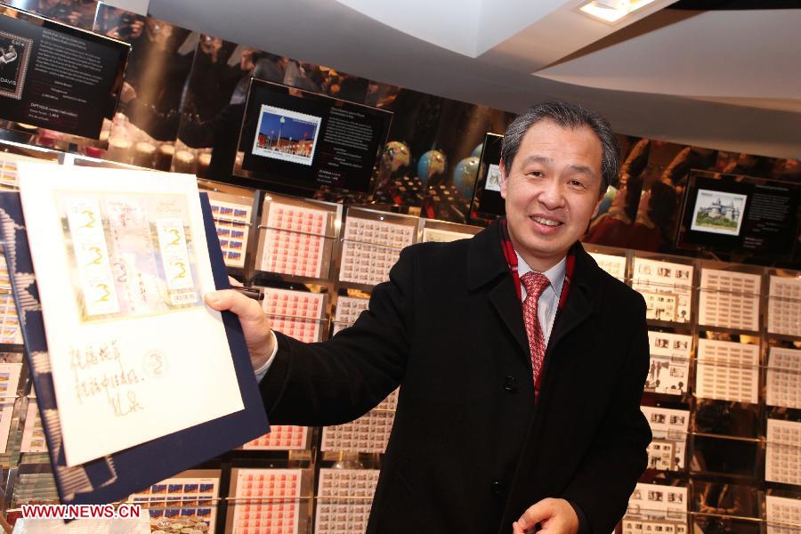 Chinese Ambassador to France Kong Quan shows the commemorative stamps for China's upcoming lunar new year, Year of the Snake, at a post office in Paris, capital of France, Jan. 4, 2013. The French postal department began to sell on Friday the commemorative stamp for China's Year of the Snake which is due to begin on Feb. 10, 2013. (Xinhua/Gao Jing) 