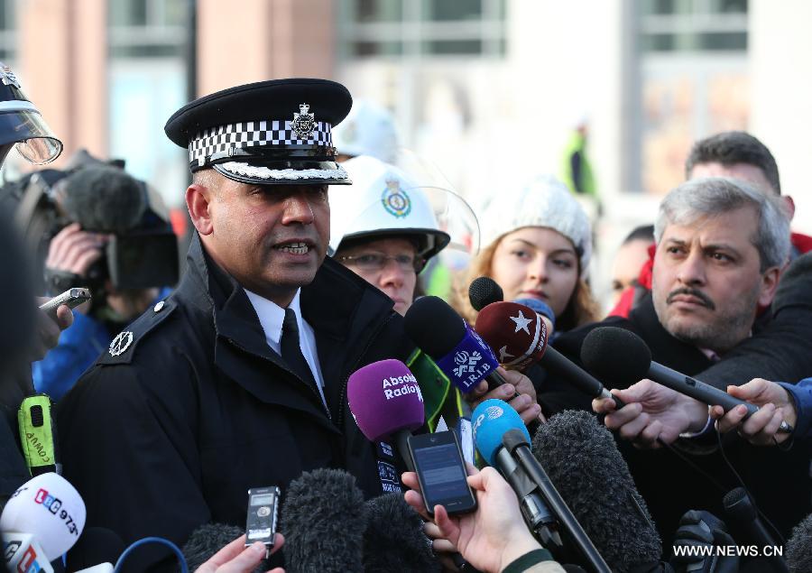 A policeman receives an interview on the helicopter crash incident in central London, Britain, Jan. 16, 2013. Two people were killed and another two were injured after a helicopter crashed into a construction crane near Wandsworth Road, south of River Thames in central London earlier on Wednesday. (Xinhua/Yin Gang)