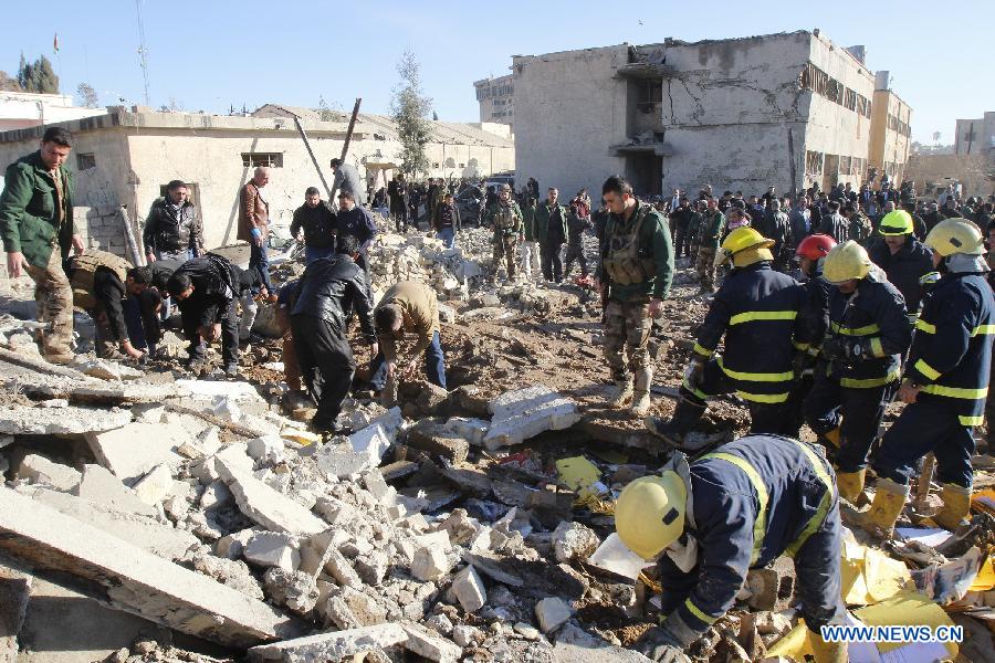 Rescuers inspect the site of a bomb attack in Kirkuk, Iraq, on Jan. 16, 2013. Up to 17 people were killed and 133 wounded in two bomb attacks targeting offices of Kurdish parties in the ethnically mixed cities of Kirkuk and Tuz-Khurmato in northern Iraq on Wednesday, according to the police. (Xinhua/Dina Assad)