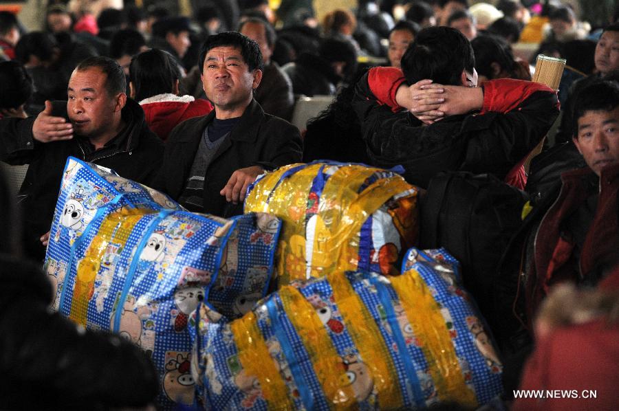 Migrant workers from central China's Henan Province wait for the train at the Hangzhou Railway Station in Hangzhou, east China's Zhejiang Province, Jan. 17, 2013. Some migrant workers have started to return home in order to avoid the Spring Festival travel peak that begins on Jan. 26 and will last for about 40 days. The Spring Festival, the most important occasion for a family reunion for the Chinese people, falls on the first day of the first month of the traditional Chinese lunar calendar, or Feb. 10 this year. (Xinhua/Ju Huanzong) 