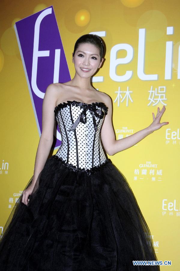 Model Vickey poses for photos during a year-end party held by EeLin Modeling Agency Ltd. in Taipei, southeast China, Jan. 17, 2013. (Xinhua)