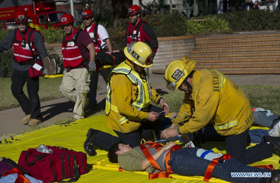 Firemen treat an injured man during an anti-terrorist drill at Claremont Colleges in Los Angeles County, Jan. 17, 2013. The three-day drill will last until Friday. (Xinhua/Yang Lei) 