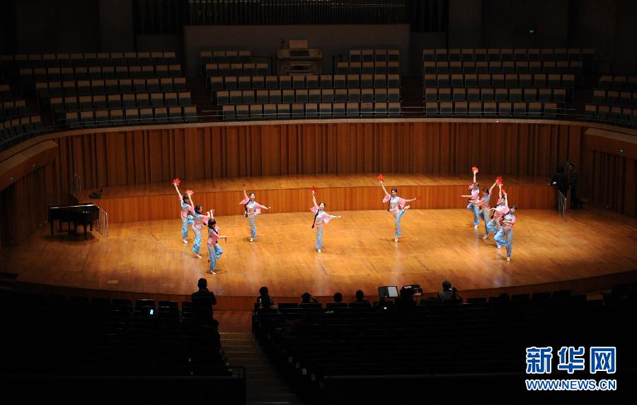 Three aged ladies lead a dancing show in the National Grand Theater on Jan. 15, 2013. (Photo/Xinhua)