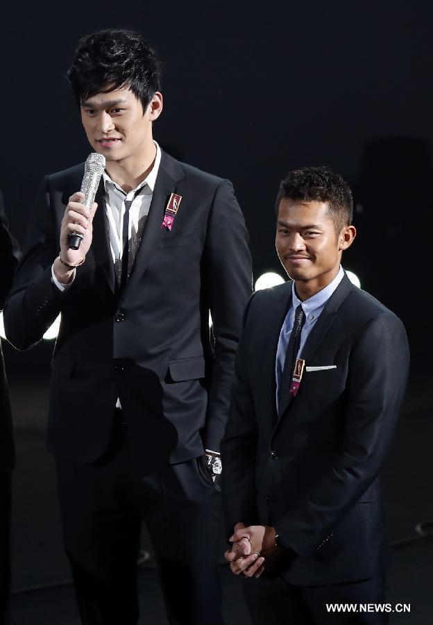 China's Olympics champion Sun Yang (L) and Lin Dan react before announcing Best Female award during the ceremony of 2012 CCTV Sports Personality of the year in Beijing, China, Jan. 19, 2013. (Xinhua/Bai Xuefei) 
