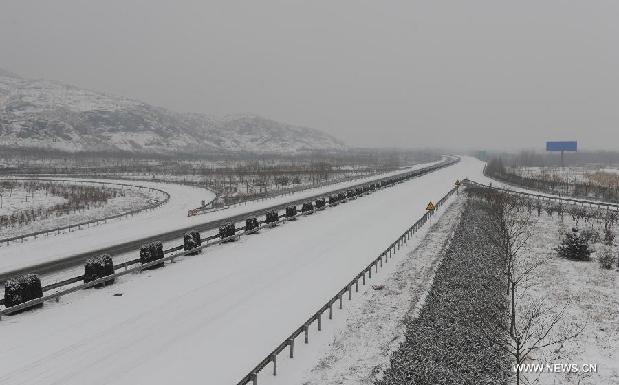 The closed Beijing-Kunming Expressway is covered with snow in Tangxian County, north China's Hebei Province, Jan. 20, 2013. Snow fell in most parts of Hebei Province on Jan. 19 evening and 19 expressways in the province have been closed. (Xinhua/Zhu Xudong)  