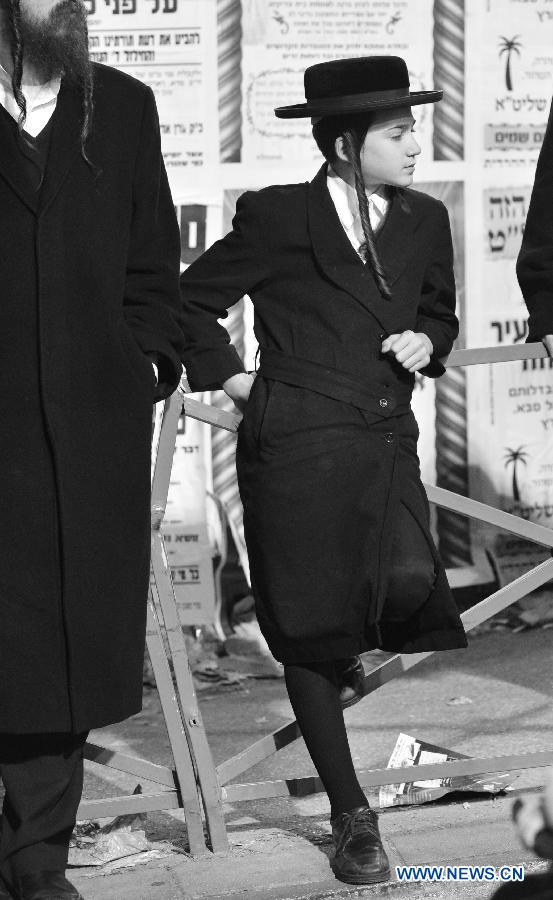 A Jewish boy attends a rally organized to welcome the visiting Grand Rabbi of the Satmar hassidic dynasty Rabbi Zalman Leib Teitelbaum from the United States in Jerusalem's ultra-Orthodox neighborhood of Mea Shearim on Jan. 20, 2013. (Xinhua/Yin Dongxun) 