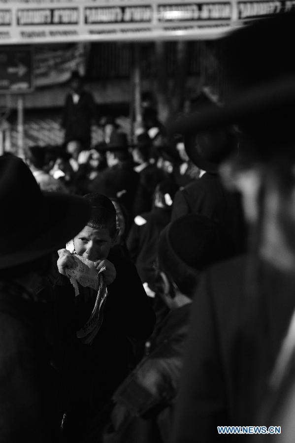 A Jewish boy attends a rally organized to welcome the visiting Grand Rabbi of the Satmar hassidic dynasty Rabbi Zalman Leib Teitelbaum from the United States in Jerusalem's ultra-Orthodox neighborhood of Mea Shearim on Jan. 20, 2013. (Xinhua/Yin Dongxun) 