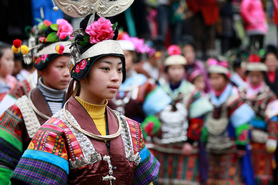 Young girls of Miao ethnic group are dressed in splendid traditional costumes for a dance held to celebrate the Miao’s Spring Festival in a village of Guizhou province, Jan. 17. (Xinhua/Huang Xiaohai)