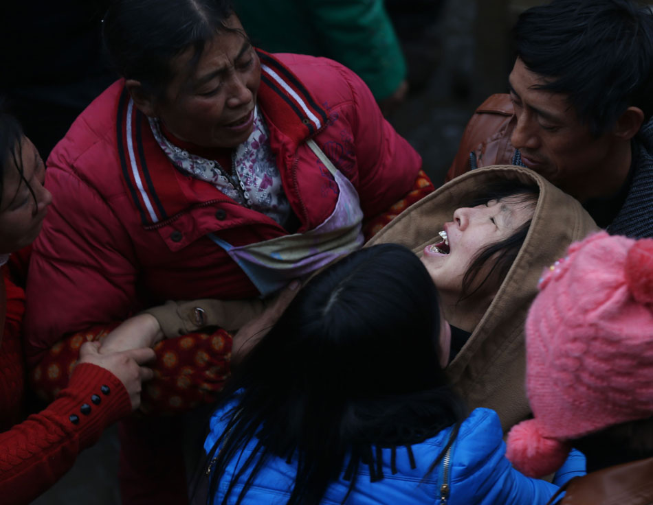 A woman wails for the loss of family members who were buried and killed in an unexpected landslide in Zhaotong, Yunnan province, Jan. 13, 2012. The landslide on Jan. 11 claimed 46 lives and left two wounded. (Xinhua/Wang Shen)